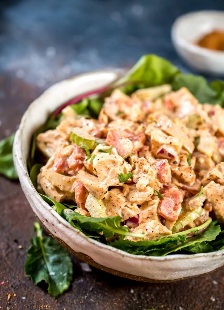 close up photo of jamaican jerk chicken salad on a bed of green lettuce