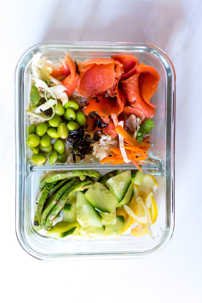 salmon sushi roll bowl ingredients in a glass meal prep container