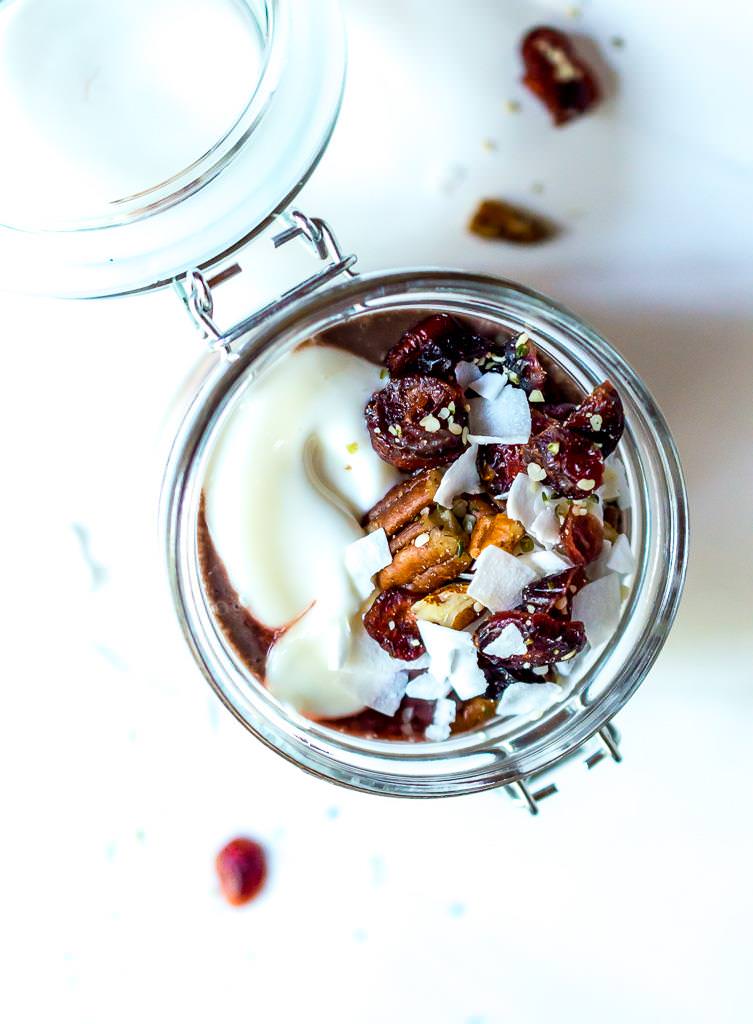 overhead view of acai yogurt parfait with nuts and coconut on top