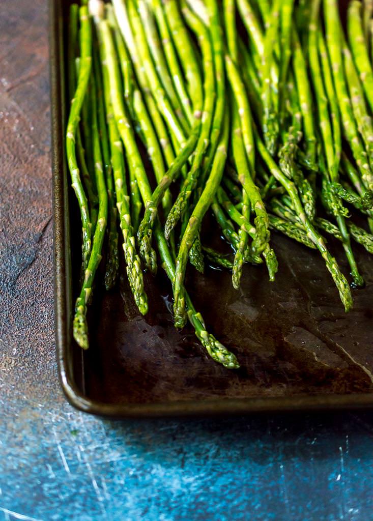 fresh asparagus on rimmed baking sheet prepped for oven roasted asparagus recipe