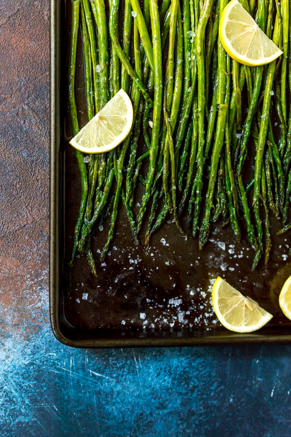 oven roasted asparagus recipe on baking sheet with lemon slices