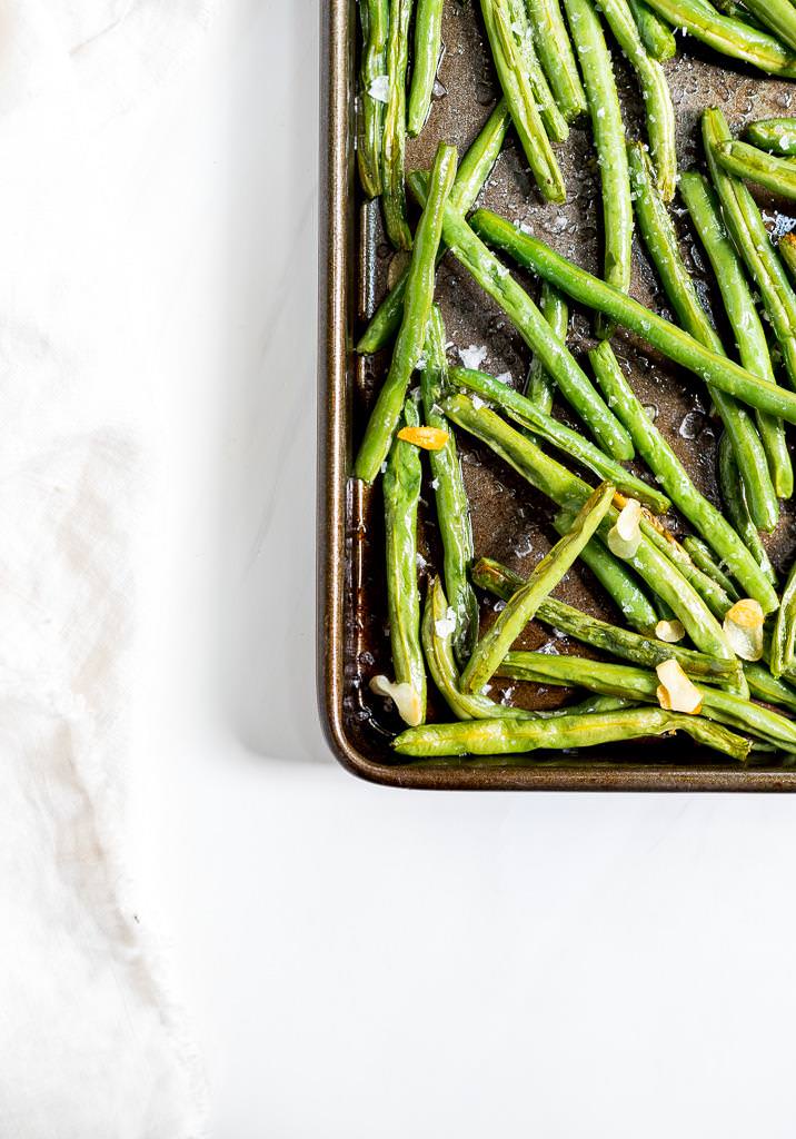 roasted fresh green beans on rimmed baking sheet
