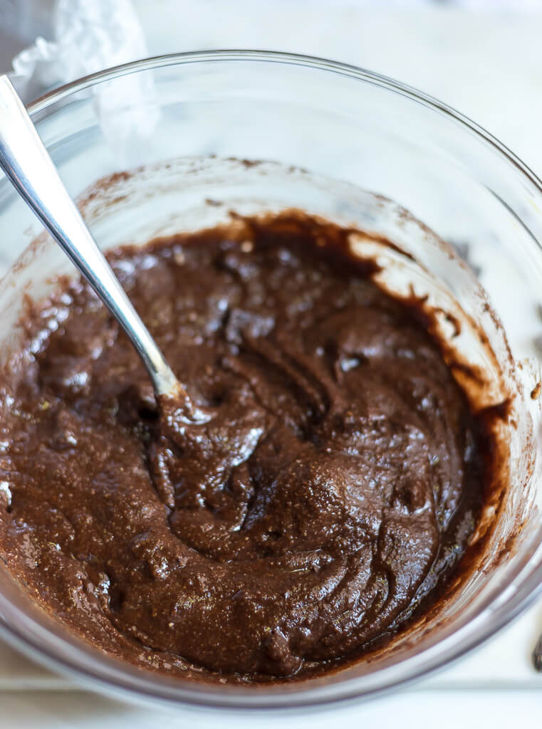 brownie batter in glass bowl with spoon