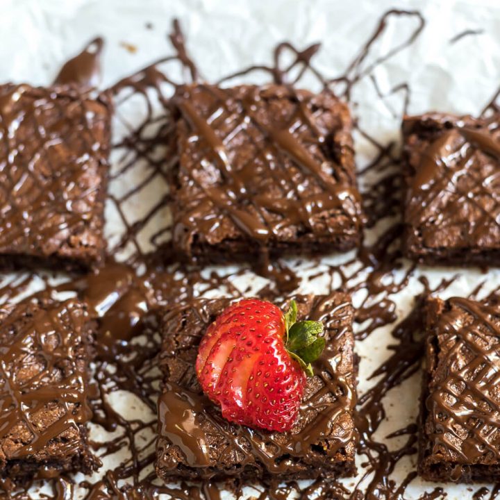 gluten free brownies with chocolate drizzle and strawberries