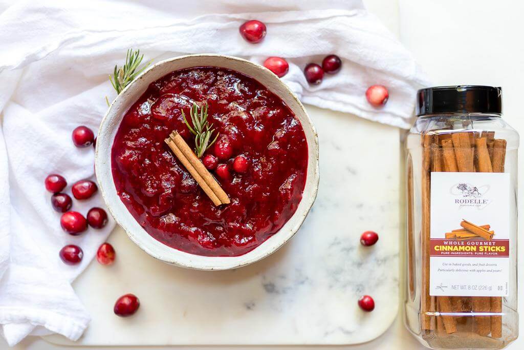 paleo cranberry sauce next to container of cinnamon sticks