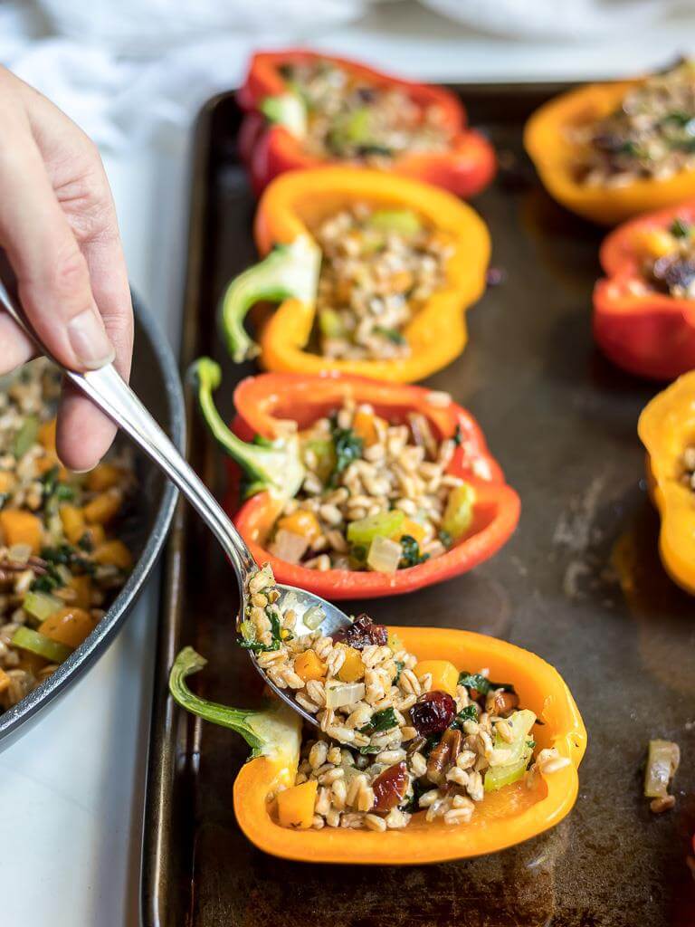 peppers getting stuffed with faro salad filling
