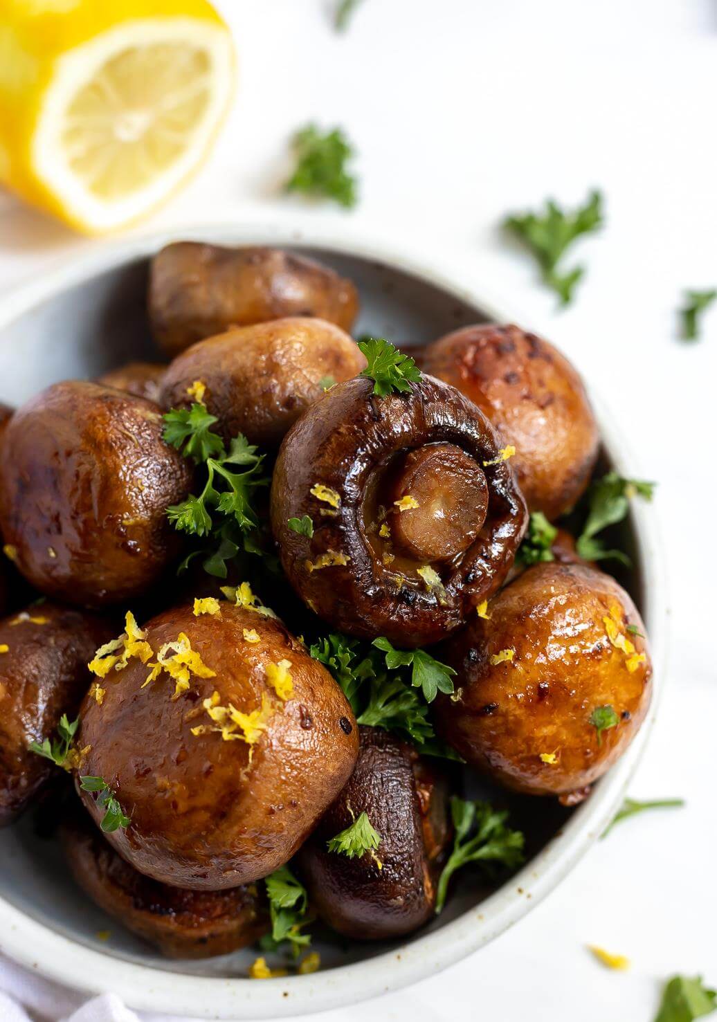 brown roasted garlic mushrooms topped with parsley and lemon zest