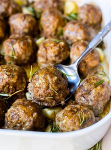 pan of meatballs with a serving spoon