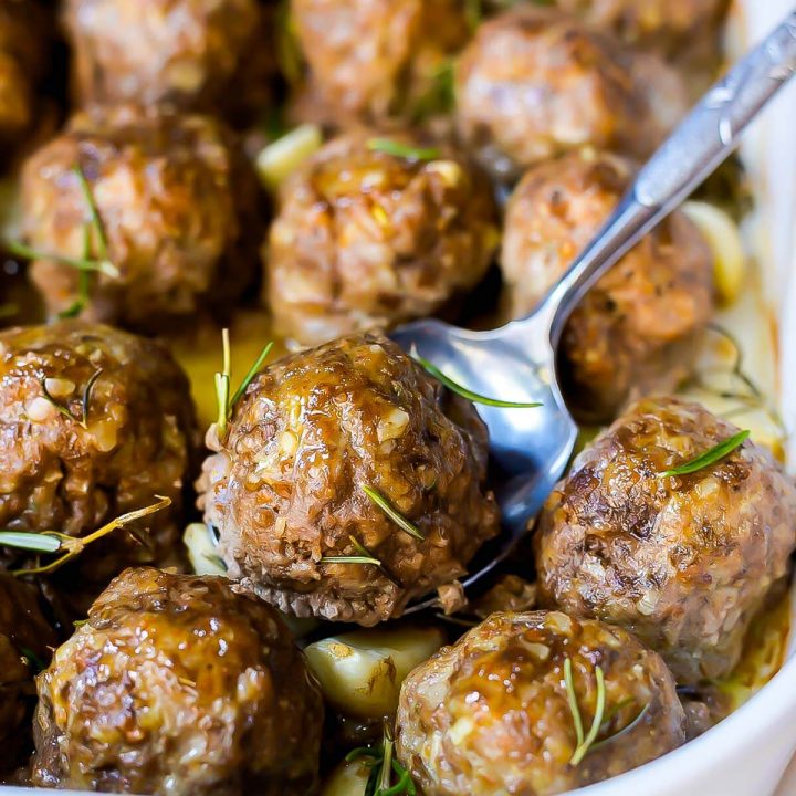 pan of meatballs with a serving spoon