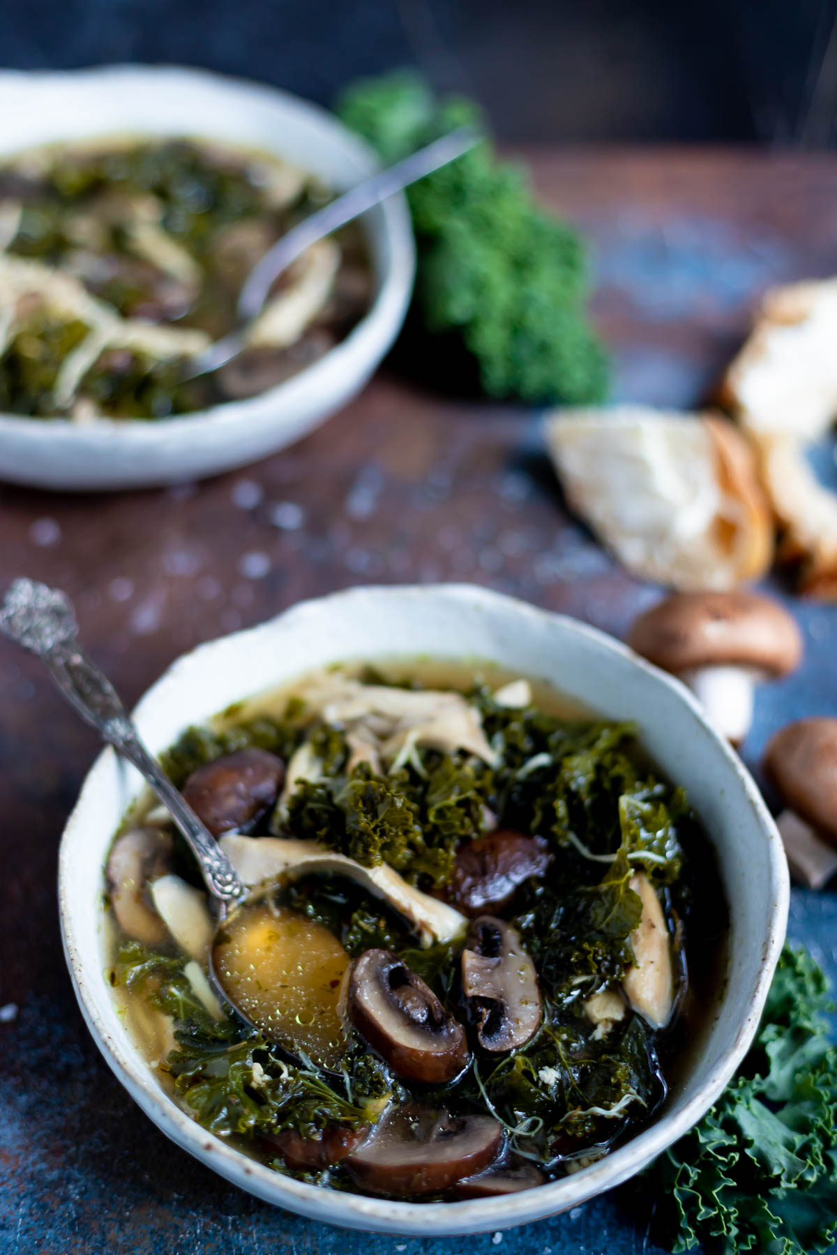mushroom kale instant pot chicken soup in white bowl with bread on the side