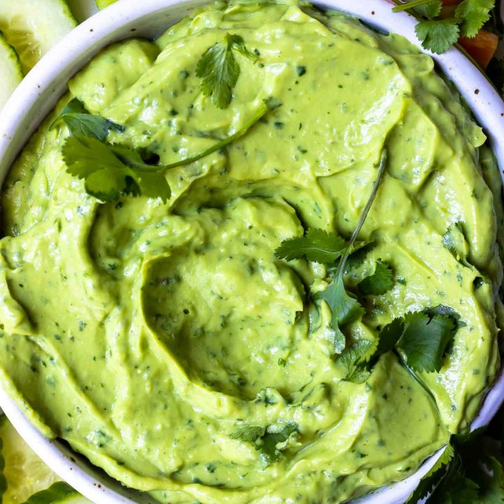 bright green and creamy avocado dip recipe topped with fresh cilantro