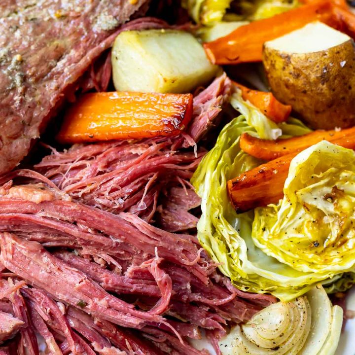 shredded corned beef recipe served on white platter with roasted vegetables
