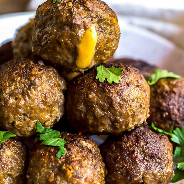 cheese stuffed meatballs on white platter