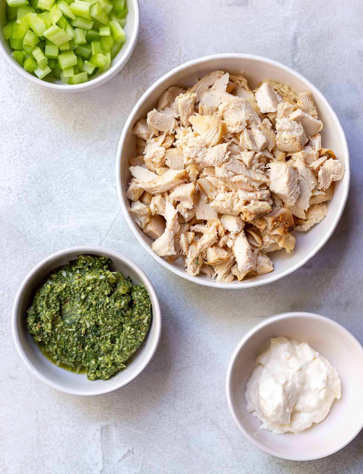 ingredients for chicken salad recipe in white bowls