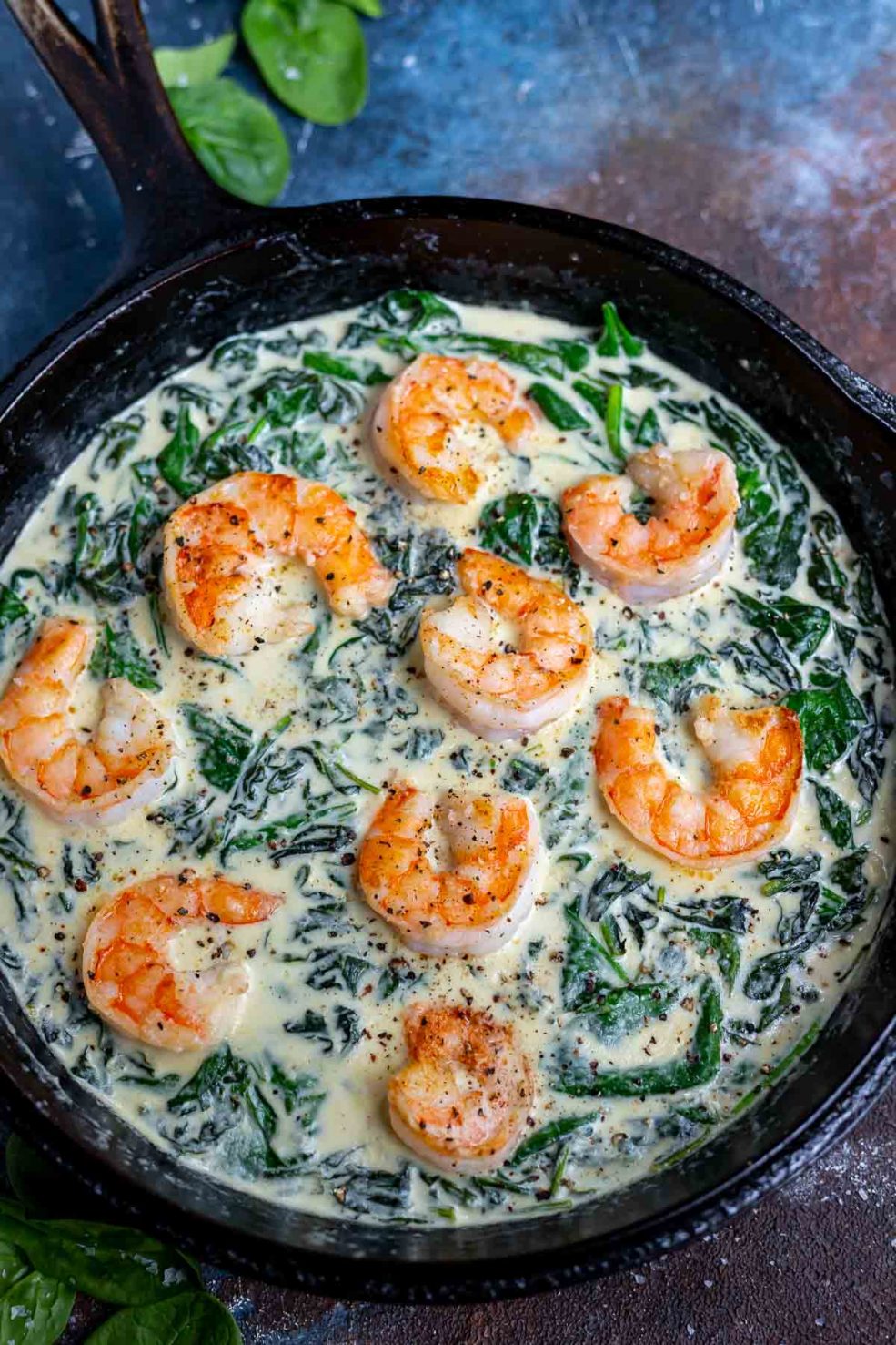 cast iron pan filled with creamed spinach and shrimp