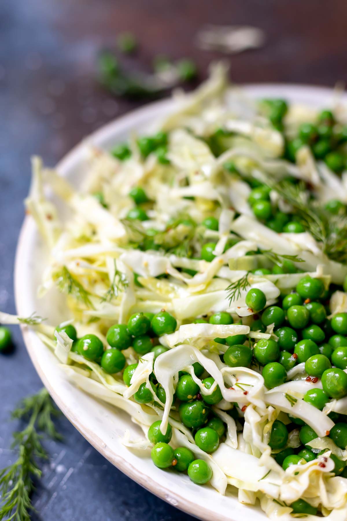 fresh green pea salad with cabbage in a white bowl