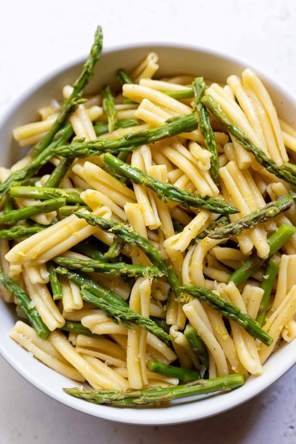 asparagus and pasta in white bowl