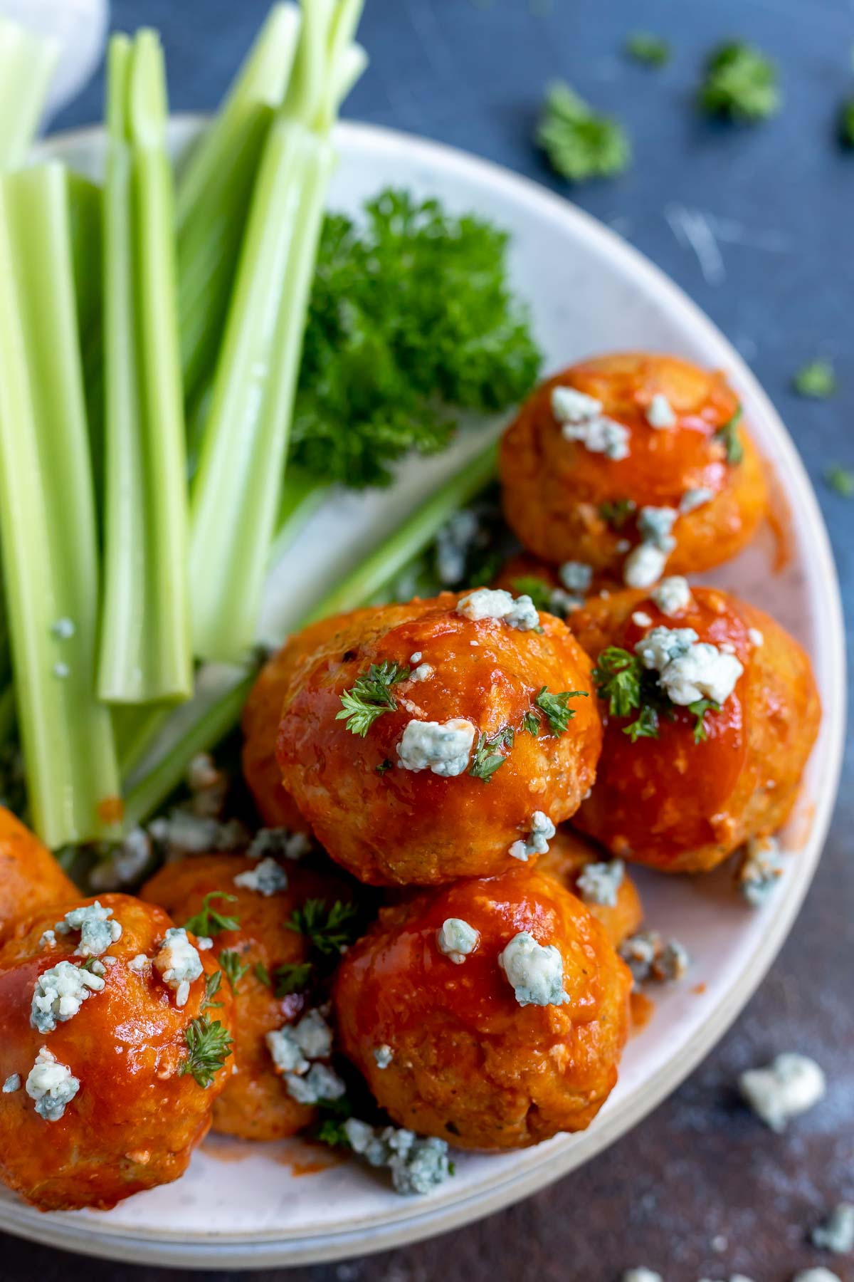 chicken meatballs with buffalo sauce and blue cheese in white bowl
