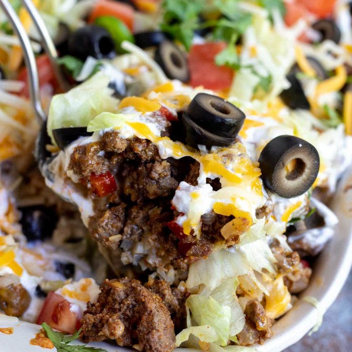 taco casserole being scooped with a serving spoon