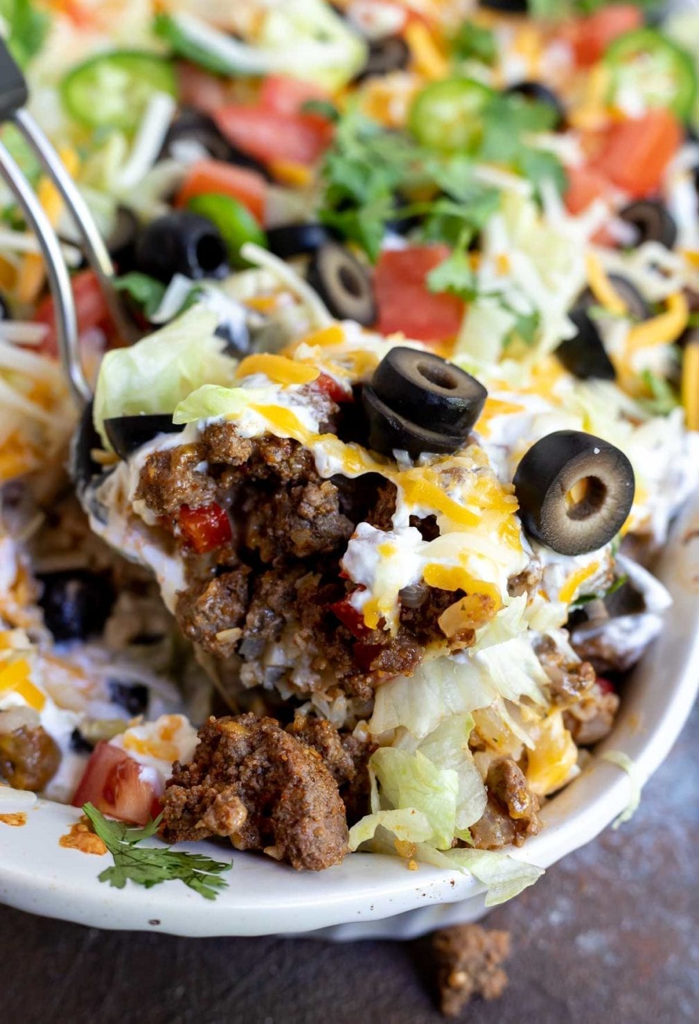 taco casserole being scooped with a serving spoon