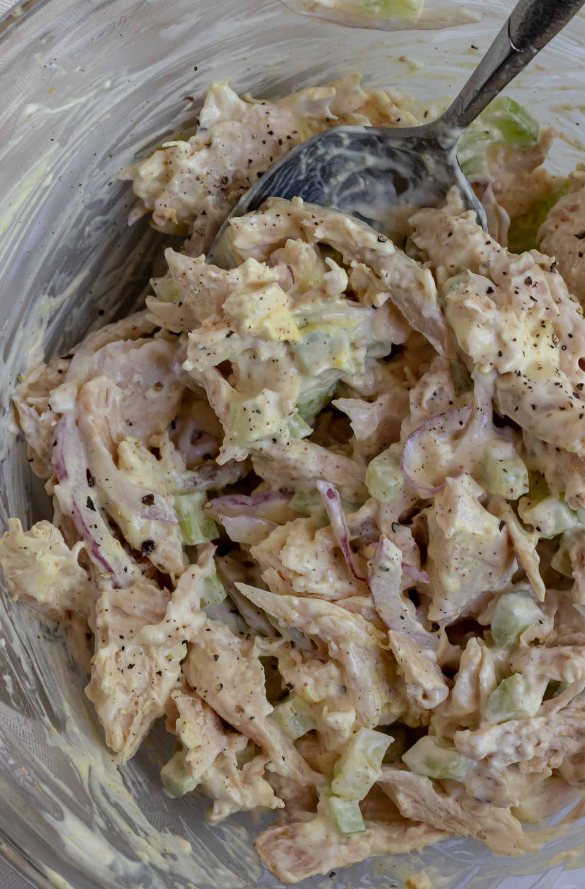 prepared chicken salad in clear glass bowl