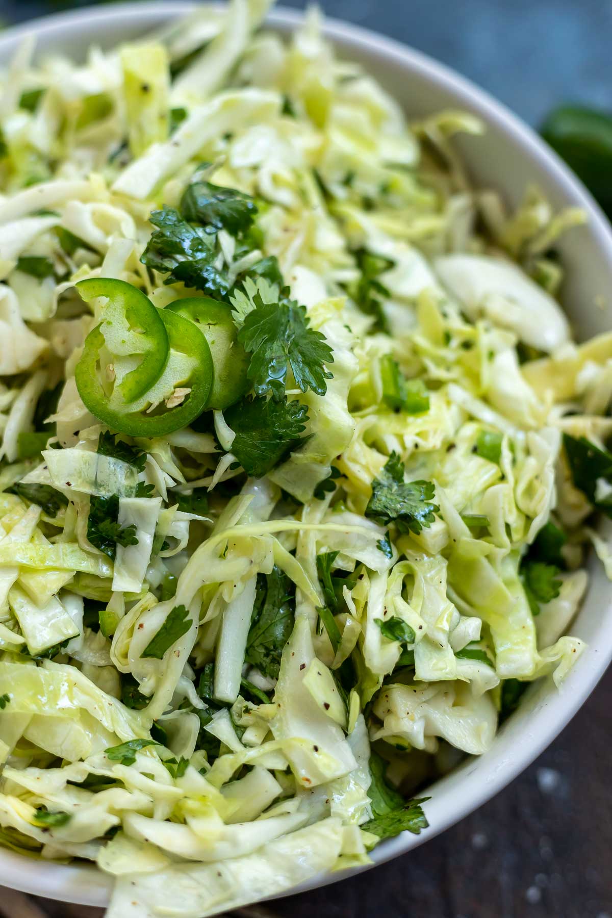 cilantro lime coleslaw in white bowl