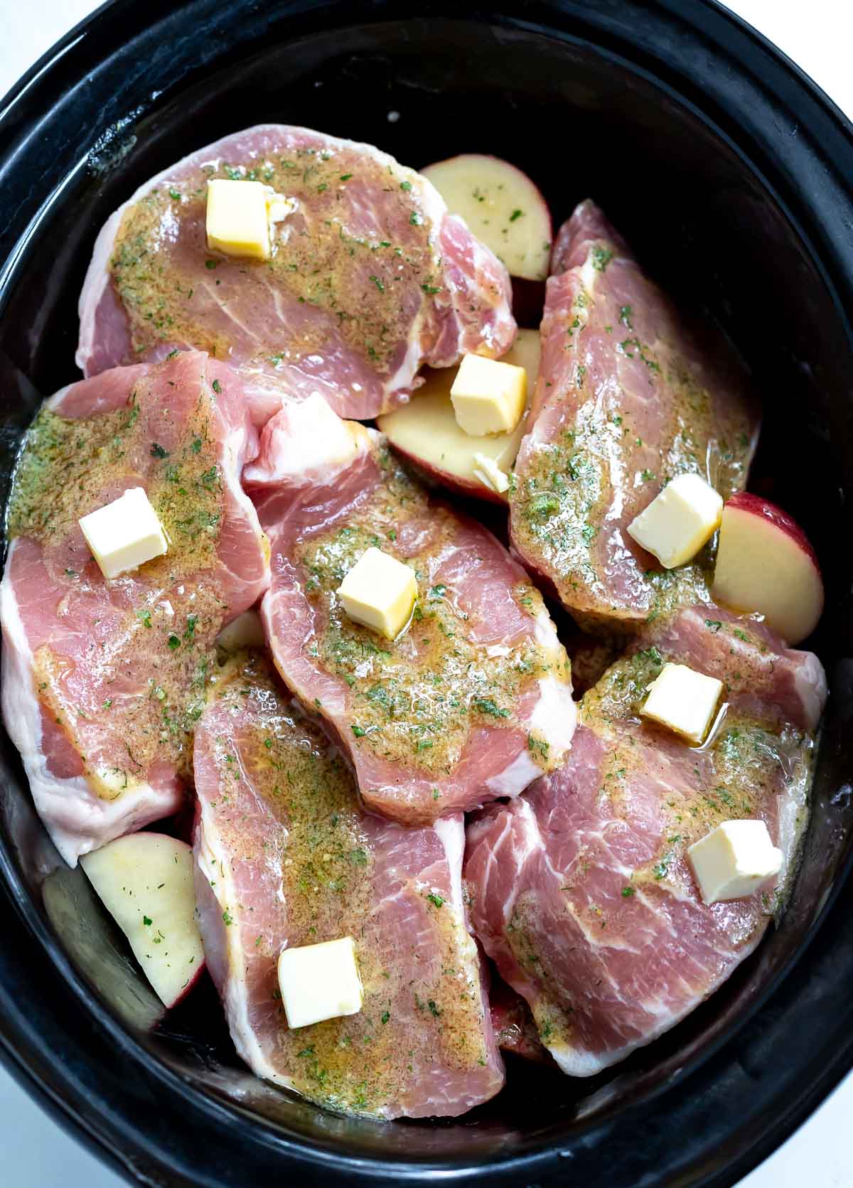 raw pork chops, ranch season and butter in slow cooker