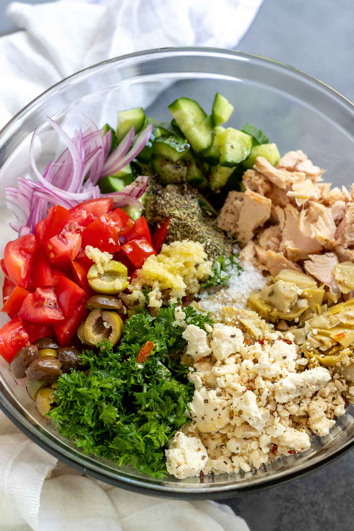 tuna salad ingredients in clear glass bowl