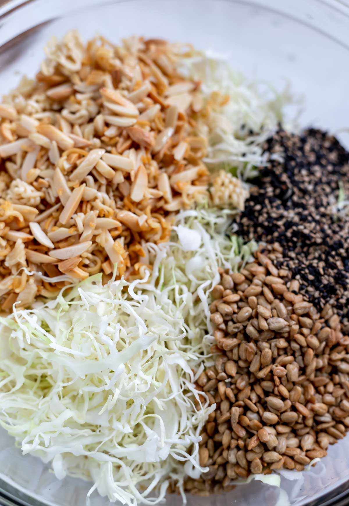 ramen coleslaw ingredients in clear glass bowl