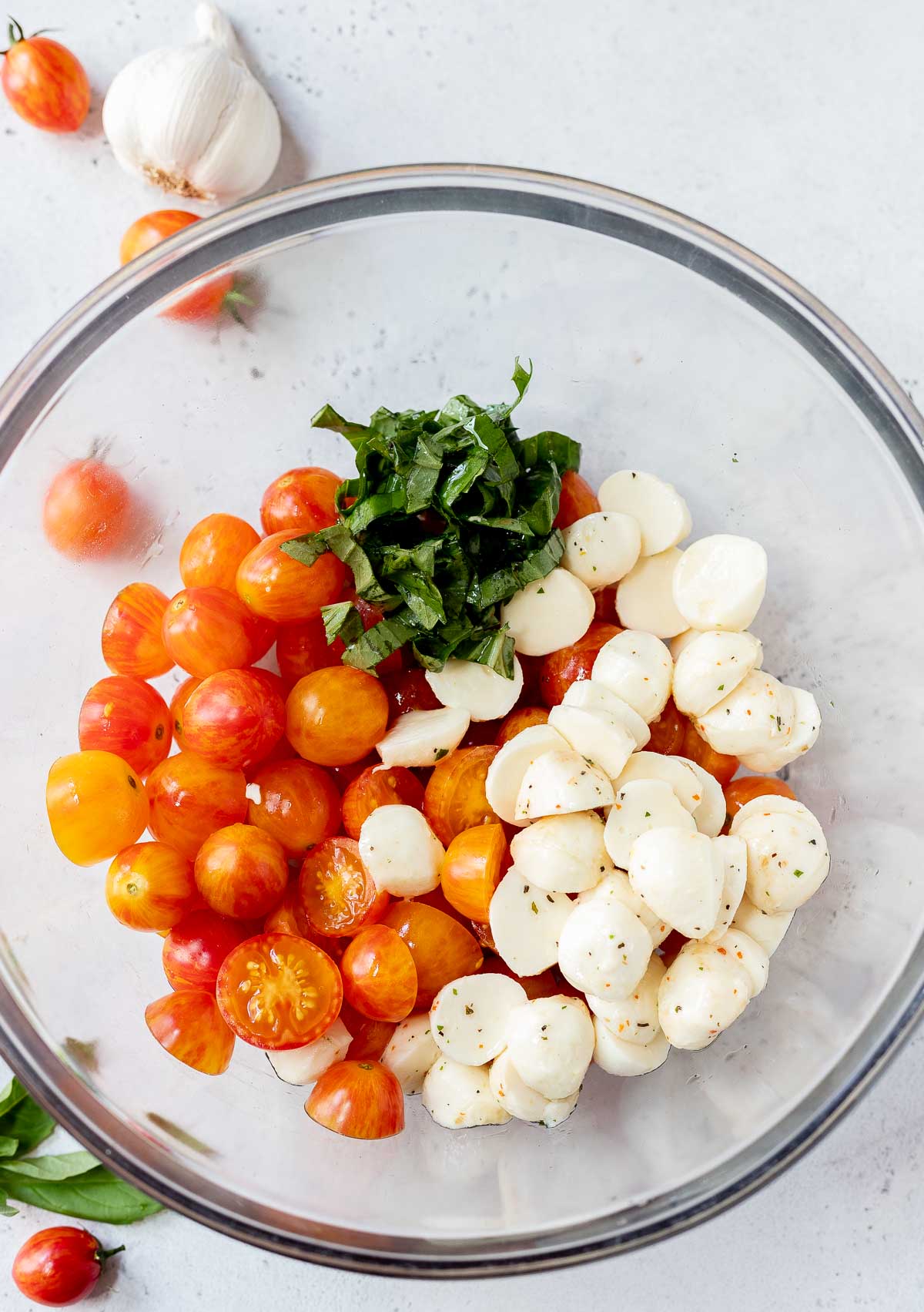 tomatoes, mozzarella and basil in glass bowl
