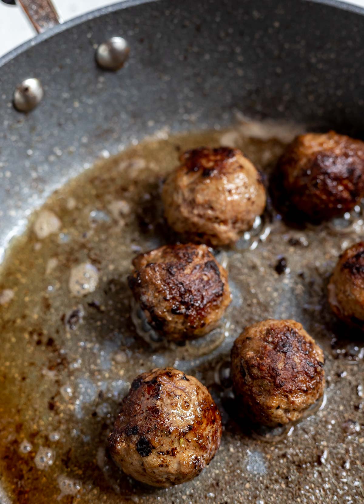 browned meatballs in fry pan