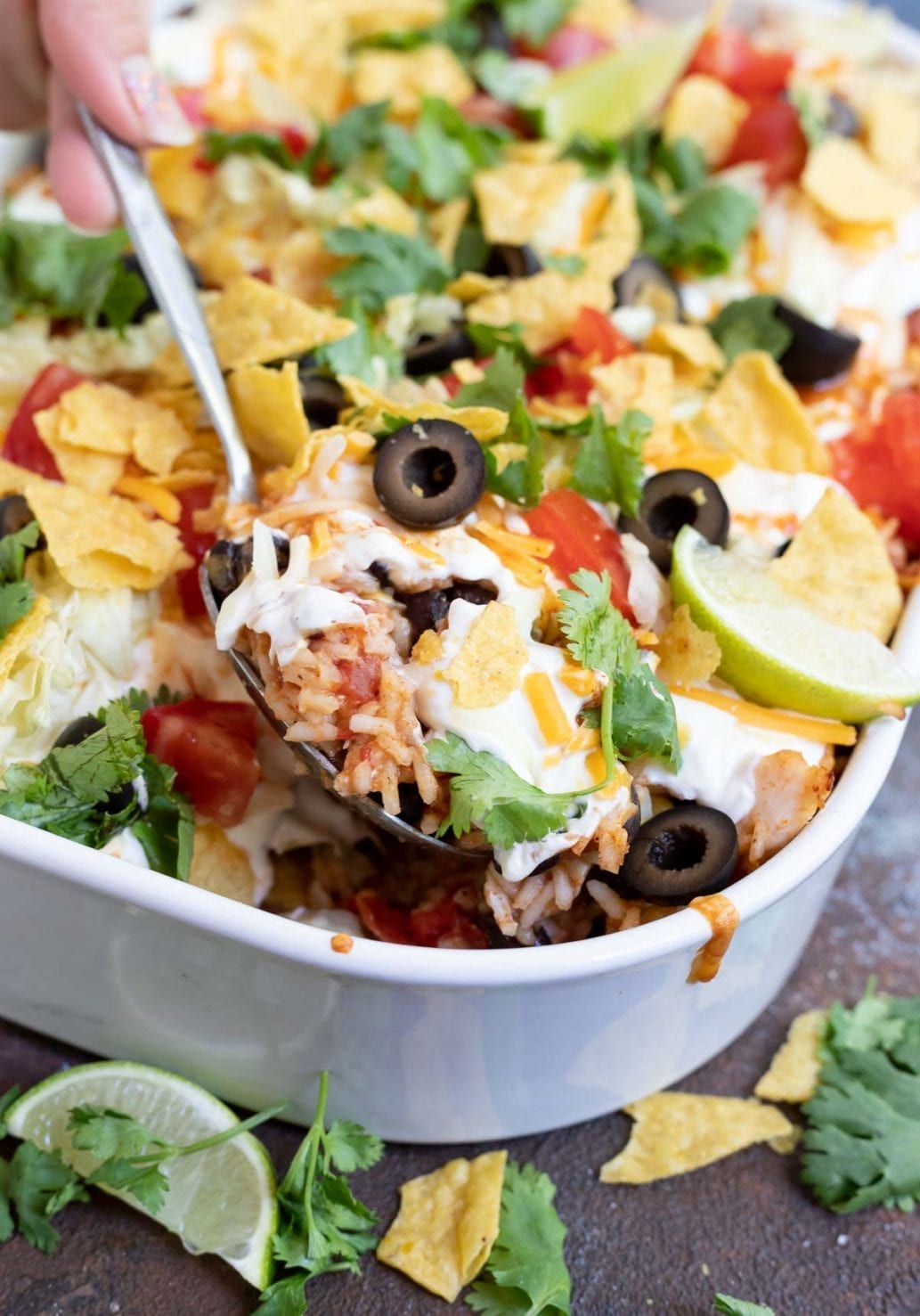 serving spoon scooping taco casserole out of dish