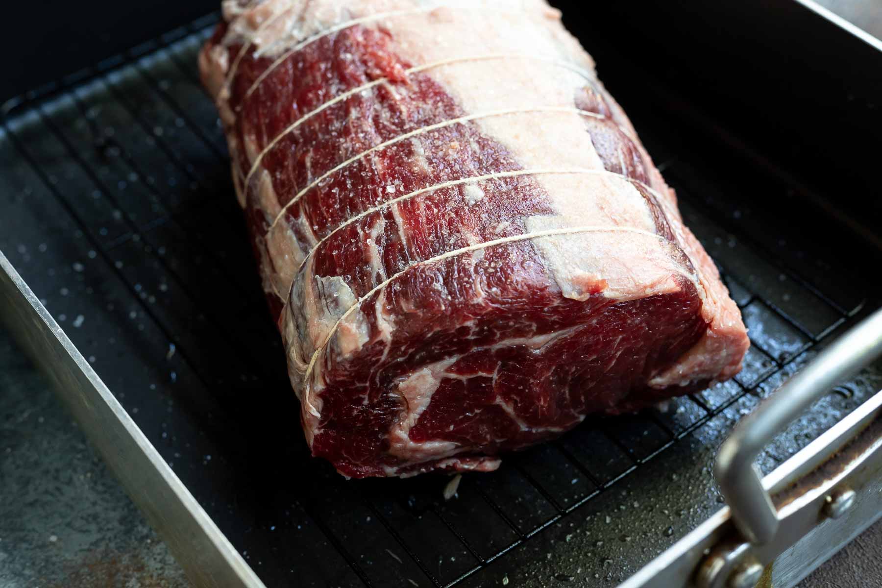 salted prime rib in roasting pan