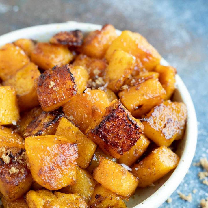 roasted butternut squash chunks in white serving bowl