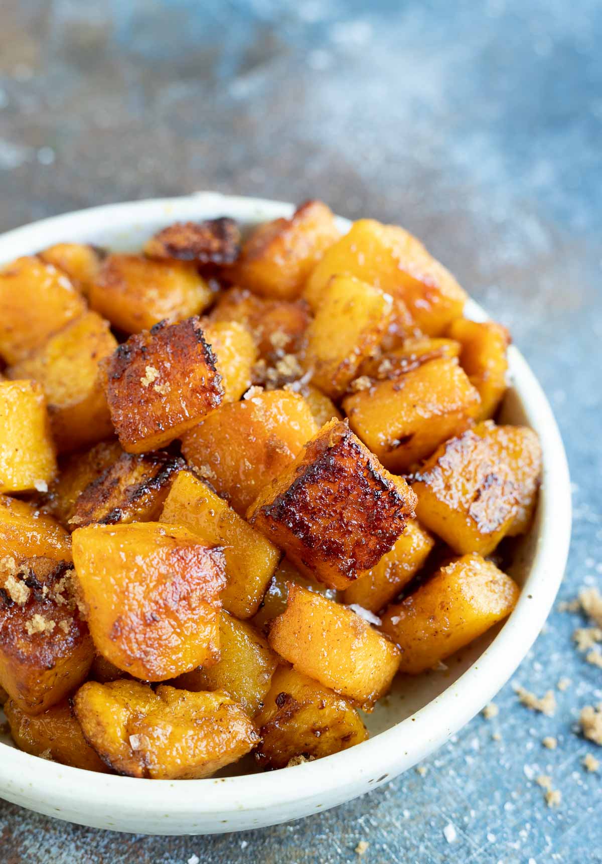 roasted butternut squash chunks in white serving bowl