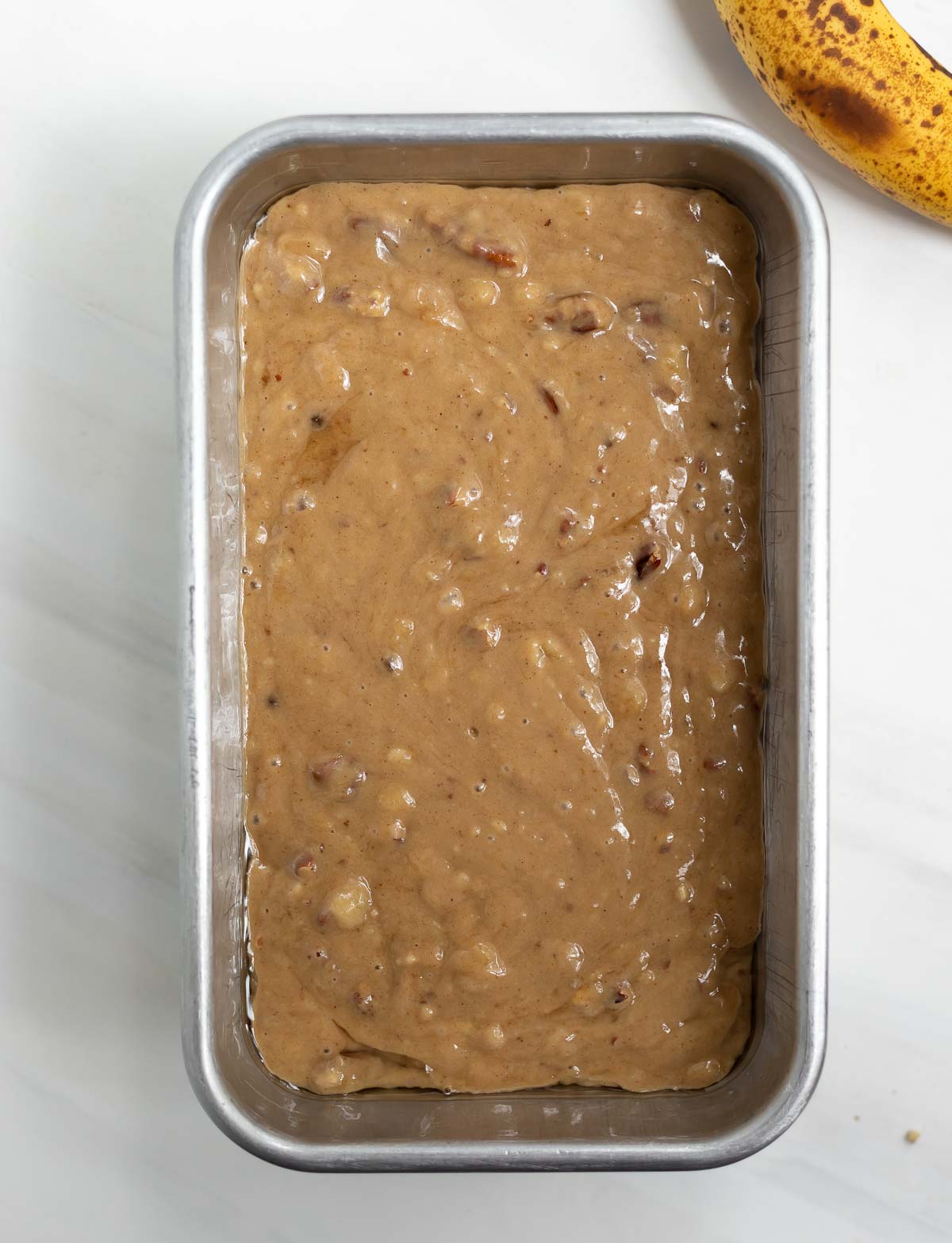 banana bread batter in silver loaf pan