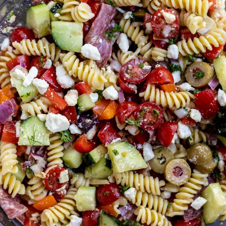 greek pasta salad prepared in clear glass bowl