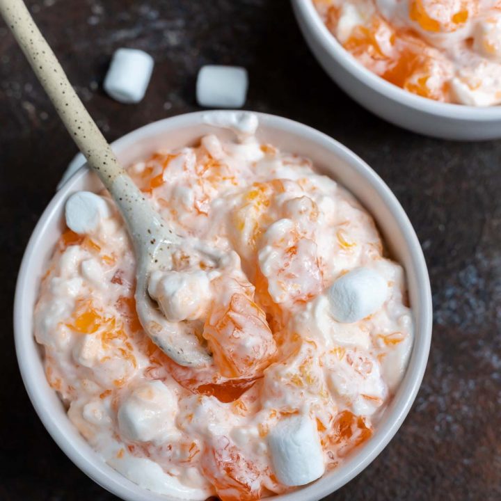 jello salad in white bowl with spoon