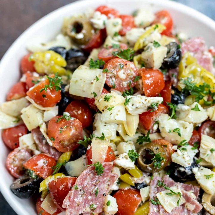 meat cheese and veggie salad in white bowl