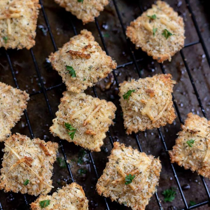 breaded baked ravioli on wire rack and baking sheet
