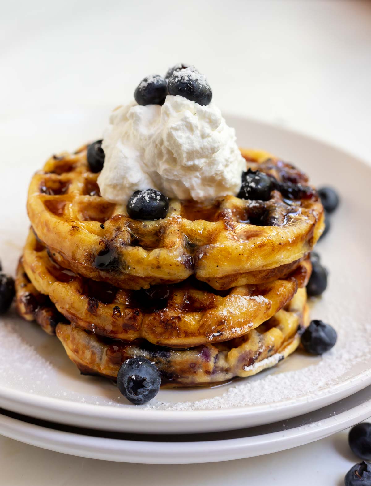 stacked waffles with blueberry cream and syrup