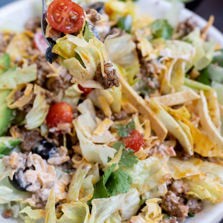 taco salad mixed together in white bowl