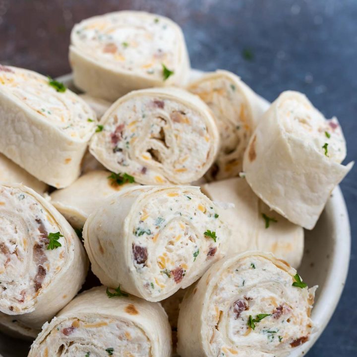 prepared pinwheels stacked in white bowl