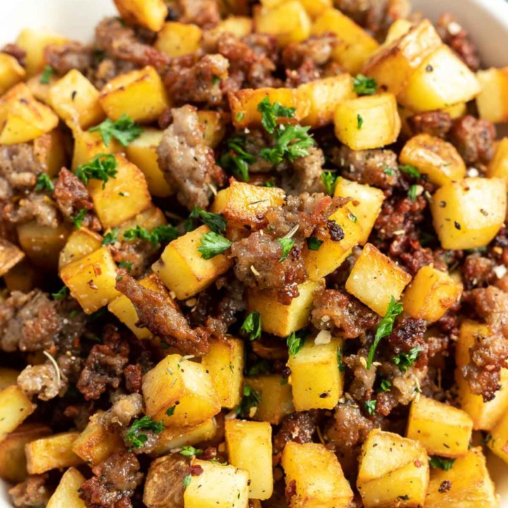 potato and sausage hash served in white bowl