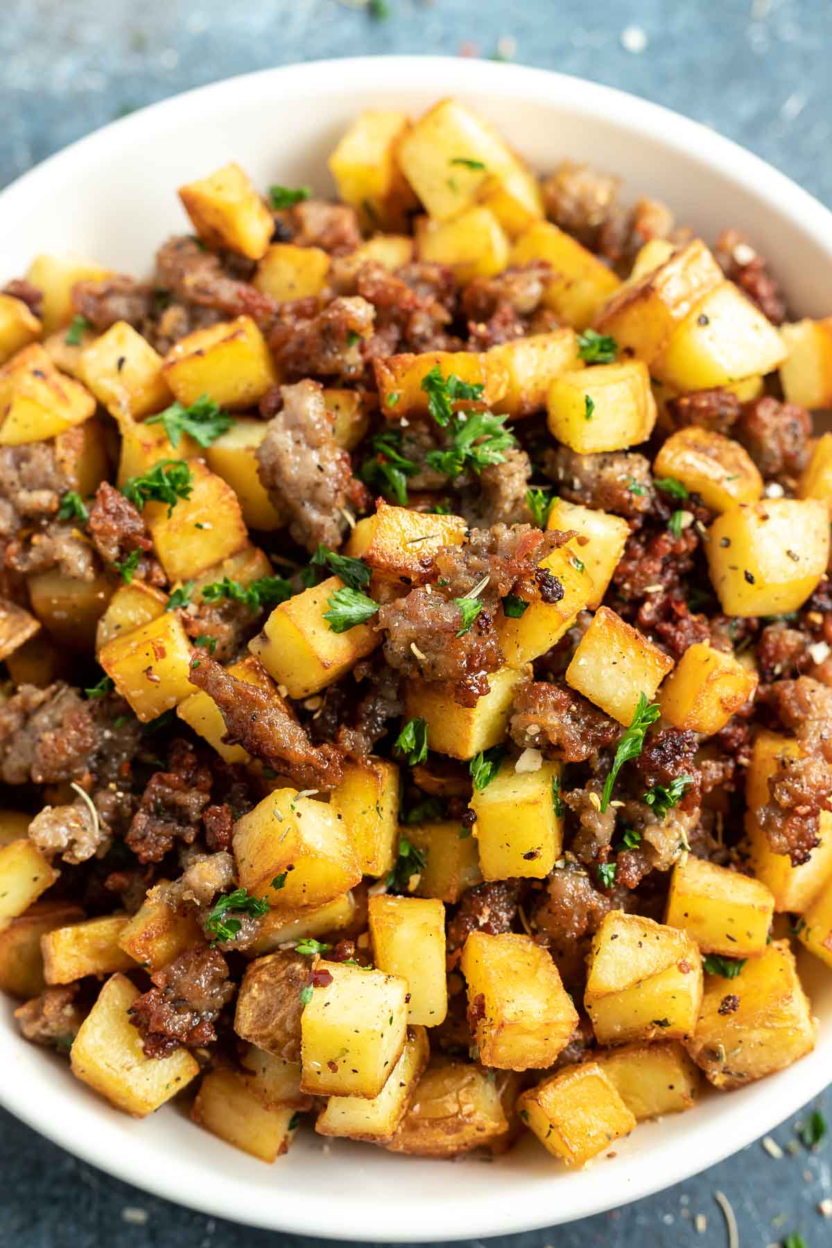 potato and sausage hash served in white bowl