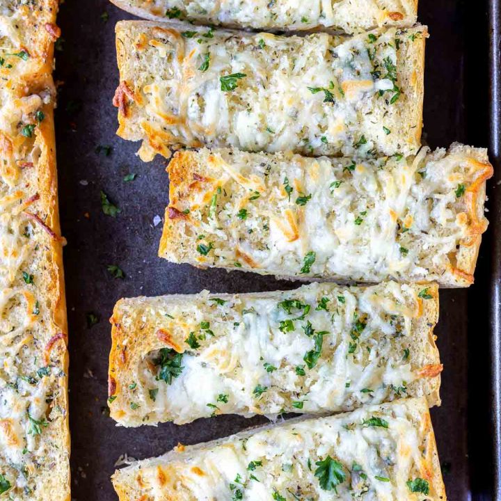 sliced baked garlic bread on baking sheet