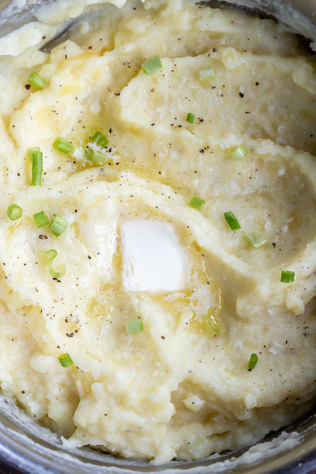 mashed potatoes topped with butter and green onions