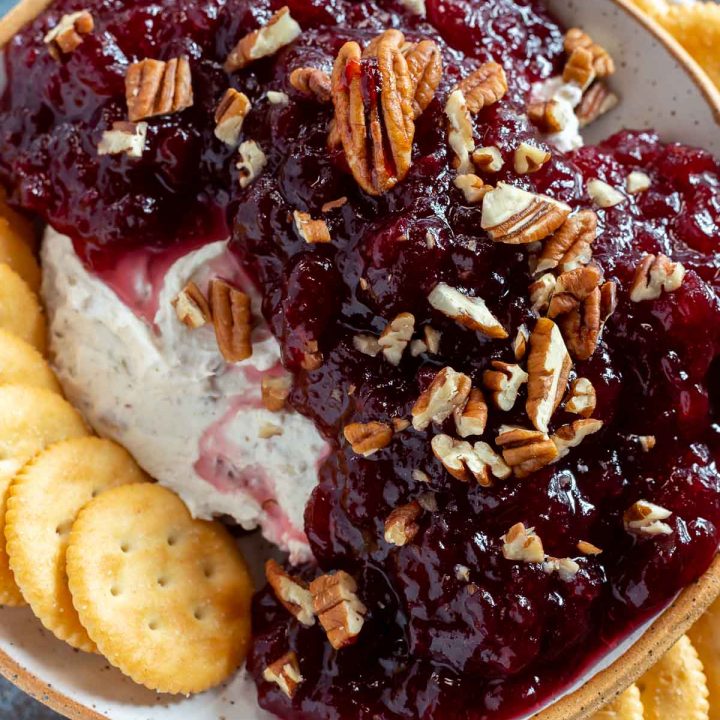 creamy dip topped with cranberry sauce served with ritz crackers