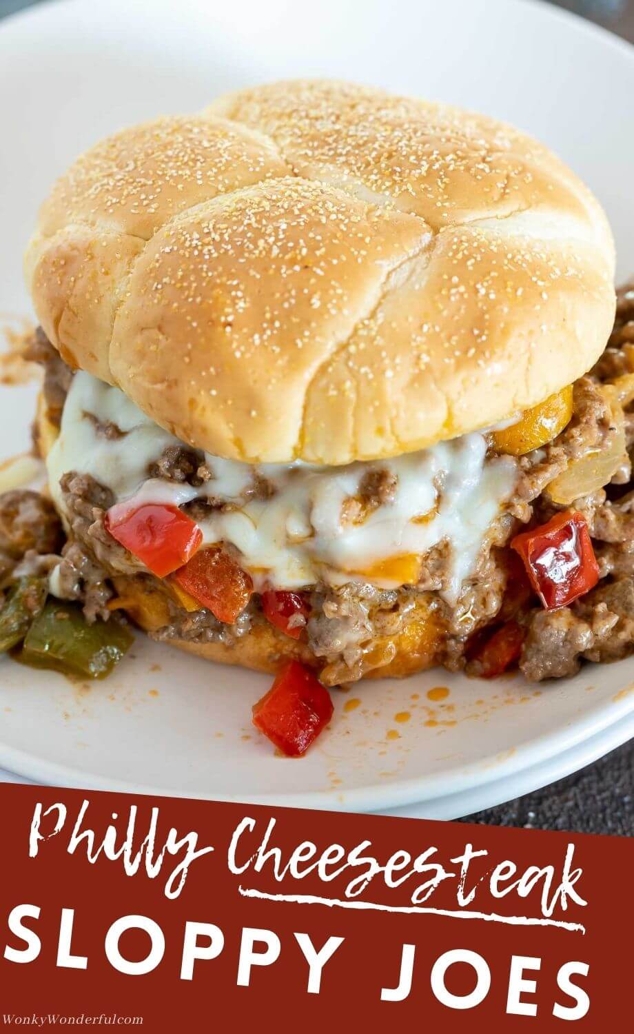 These Philly Cheesesteak Sloppy Joes have the great flavors of a cheesesteak in a quick, easy weeknight dinner. Sloppy Joes filled with peppers, onion and melty cheese. #sloppyjoesrecipes #phillycheesesteaksloppyjoes #dinnerrecipes #easydinnerrecipes #groundbeefrecipes via @wonkywonderful