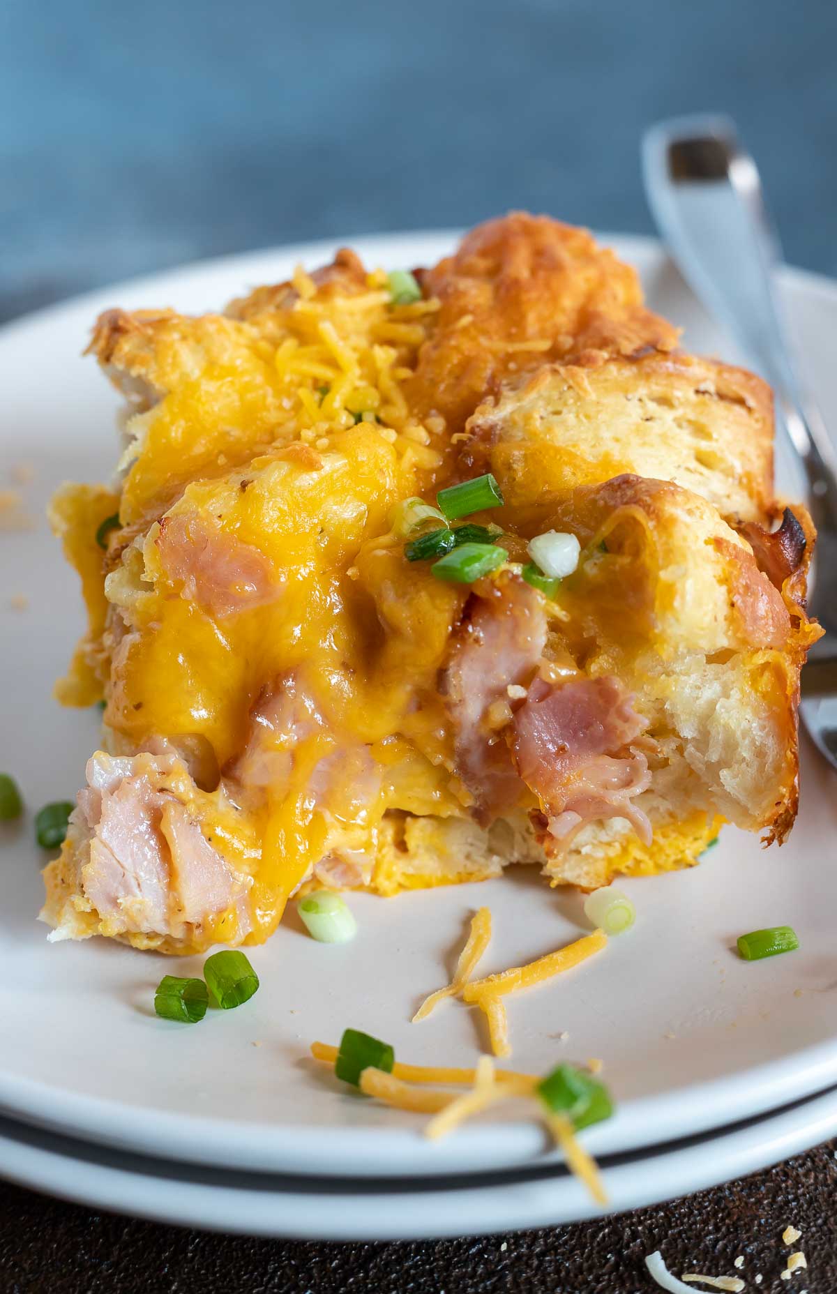 serving of breakfast casserole on white plate with fork
